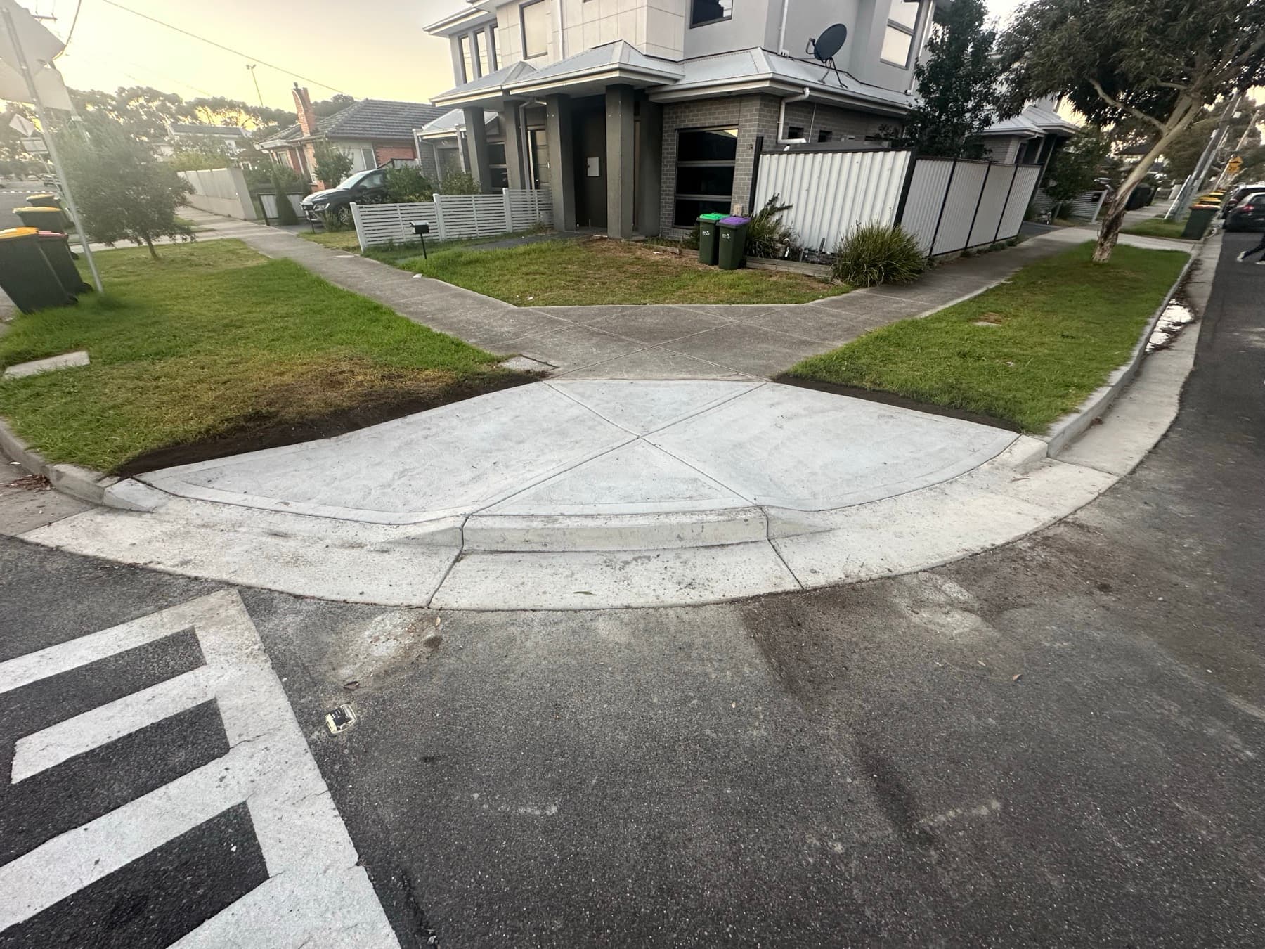 Finished corner vehicle crossover at dusk with new kerb and splay